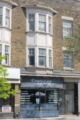 Fototapeta premium exterior commercial and apartment block with sign of Copy Cat Reproductions located at 746 Danforth Ave, Toronto