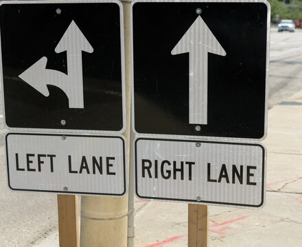 two road signs with arrows