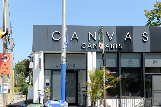 exterior building facade and sign of Canvas Cannabis located at 730 Danforth Av (at Pape), Toronto