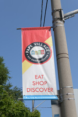 Fototapeta premium pole-mounted projecting banner at Pape Village, Toronto