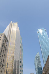 Fototapeta premium looking east on Front St W to Royal York hotel, Royal Bank Plaza, L-Tower condos, and CIBC Square in Toronto, summertime