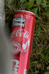Fototapeta premium obstructed view of a discarded Coca-Cola can with special soccer tournament banding in Toronto