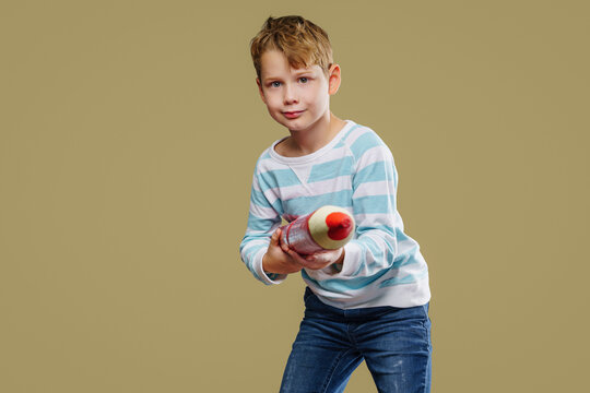 Boy child with XXXL pencils, ready to go back to school. Isolated on free background.