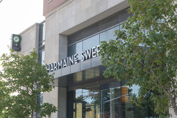 Fototapeta premium exterior building facade and sign of Charmaine Sweets, a bakery, located at 939 Eglinton Av E, East York, Toronto