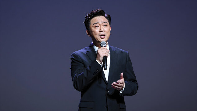 Opera singer holding microphone on stage