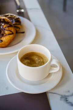 Coffee and chocolate pastry on breakfast table, travel holiday leisure and cafe background