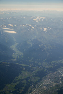  Aerial view of Swiss Alps mountains, alpine valley and town from airplane, travel and tourism