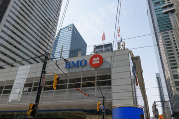 Fototapeta premium exterior building facade and corporate logo sign of BMO Financial Group outside headquarters at First Canadian Place, northwest corner of 100 King St W and Bay St, Toronto