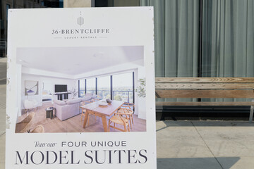 Fototapeta premium a-frame sidewalk sign near 36 Brentcliffe, a recently completed 20-storey residential tower in Leaside, developed by Camrost Felcorp, Toronto