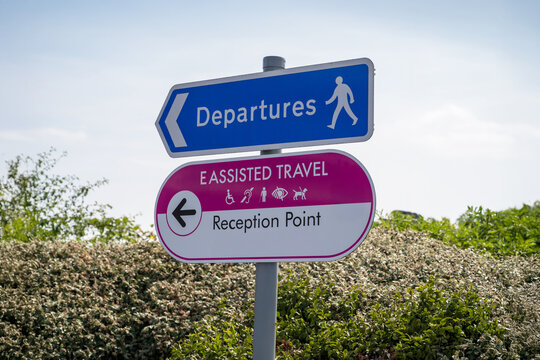 East Midlands Airport, Leicestershire, UK, July 24, 2026: Departures and assisted travel reception point signs at the airport