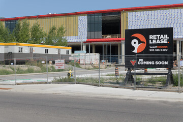 Fototapeta premium wood pylon Retail Lease with Canadian Tire coming soon signage at 147 Laird Dr, SmartCentres Leaside development, East York, Toronto