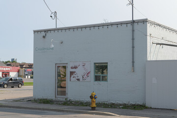 Fototapeta premium ghost sign on the exterior of Charmaine Sweets in its former location, an “iconic white brick building” at 115 Vanderhoof Av, East York, Toronto