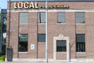 Fototapeta premium exterior building facade and sign of LOCAL Public Eatery Leaside, a restaurant, located at 180 Laird Dr (East York) Toronto