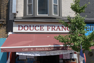 Fototapeta premium exterior building facade and sign of Douce France, a gourmet grocery store, located at 820 Danforth Av, Toronto