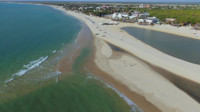 Aerial view of the sandy coastline and turquoise waters meeting the town of Morondava, Menabe, Madagascar.