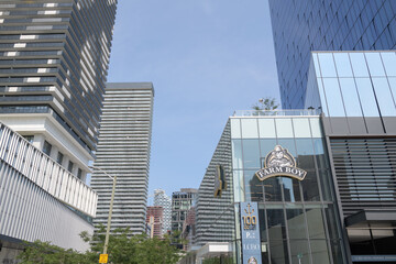 Fototapeta premium exterior building facades and signs incl Farm Boy, a food market, located at 100 Queens Quay E, Sugar Wharf Condominiums, Toronto