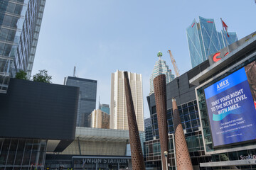 Fototapeta premium looking north from Maple Leaf Square outside Scotiabank Arena with digital billboard featuring advertisement by American Express, Toronto