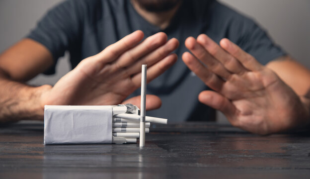 Caucasian man reject cigarettes. No smoking
