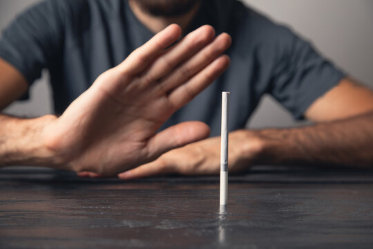Caucasian man reject cigarettes. No smoking