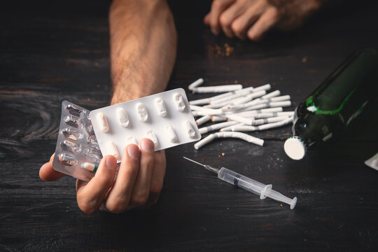Drug addict with a syringe of heroin.