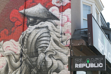 Fototapeta premium mural and sign outside Plant Republic, a cannabis store, located at 1031 Pape Av, East York Toronto