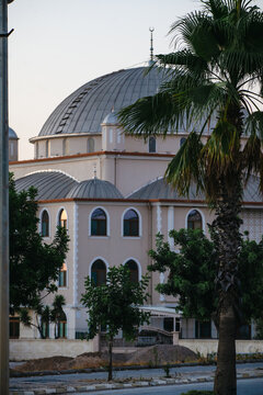 Antalya, Turkey, July 26, 2026: Mosque with twin minarets and domed architecture at sunset