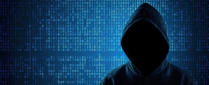 Hacker in anonymous hoodie with digital binary code for cybercrime data security