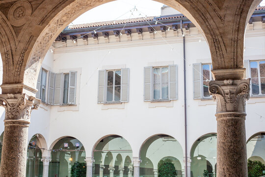 Inner Courtyard View of Historic Building framed by Arch and Columns in Milan City Center Italy.