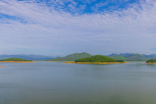 Kaeng Krachan Dam Scenic View of Lake and Mountains,Wide-angle scenic view of Kaeng Krachan Dam in Thailand, featuring numerous small, lush green islands scattered across the vast, calm turquoise.