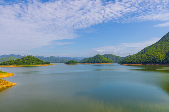 Kaeng Krachan Dam Scenic View of Lake and Mountains,Wide-angle scenic view of Kaeng Krachan Dam in Thailand, featuring numerous small, lush green islands scattered across the vast, calm turquoise.