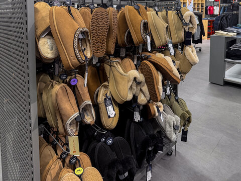 Poznan, Poland - January 19, 2026: Jack Wills slippers displayed on a store rack, showcasing diverse suede footwear with fleece lining for cozy home relaxation and comfort shopping