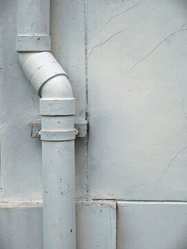Old rusty metal pipe on the wall