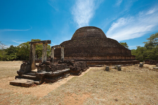 Scene featuring ancient Buddhist dagoba (stupe) Pabula Vihara. Ancient city of Polonnaruwa, Sri Lanka, with brich