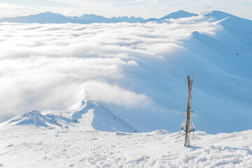 Skiing in snow on top of mountain above clouds in Zakopane, Poland © Alena Malinouskaya