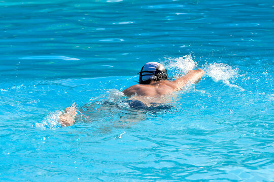 An athletic Man swimming in the pool