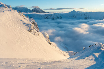 Winter mountain sunset landscape above clouds in Zakopane, Kasprowy wierh, Poland. © Alena Malinouskaya