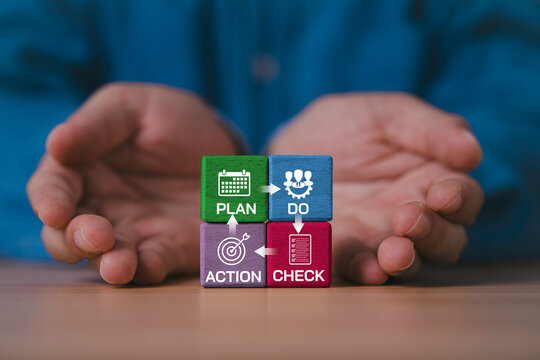 Businessman giving colorful wooden blocks with Plan Do Check Action cycle for PDCA concept , continuous improvement, quality management, business process, workflow, teamwork and productivity strategy.