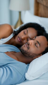 Couple sleeping peacefully while cuddling in a comfortable bed, healthy sleep routine, relationship intimacy, nighttime rest, emotional security, relaxation, bedroom comfort, wellness, calm