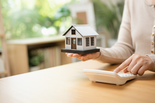 real estate mortgage with house savings; a model and coins arranged for property planning. real guides buyer choices, estate frames the scene, and mortgage adds useful meaning. For useful context.