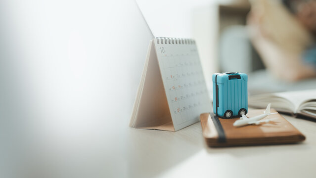 travel planning suitcase with vacation calendar; a suitcase and arranged for a future journey. travel guides buyer choices, planning frames the scene, and suitcase adds useful meaning.