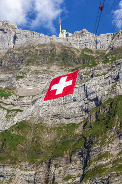 Huge Swiss national flag (80mx80m, which is the biggest Swiss flag in the world) hangs on the Saentis mountain on National Day