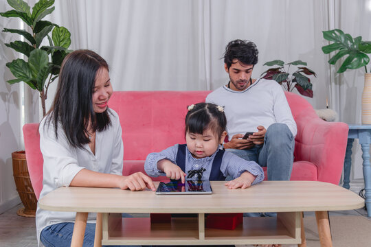 Happy family spending quality time together at home with parents' children enjoying fun and relaxed moment around a table.