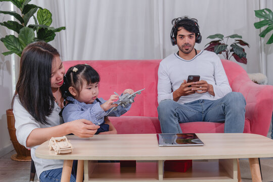 Happy family spending quality time together at home with parents' children enjoying fun and relaxed moment around a table.
