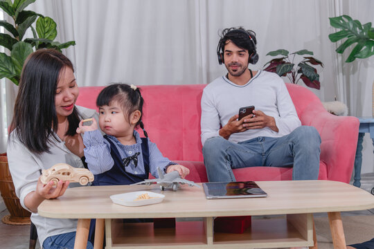 Happy family spending quality time together at home with parents' children enjoying fun and relaxed moment around a table.