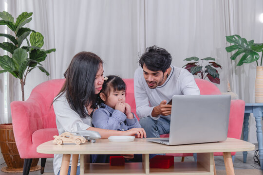 Happy family spending quality time together at home with parents' children enjoying fun and relaxed moment around a table.