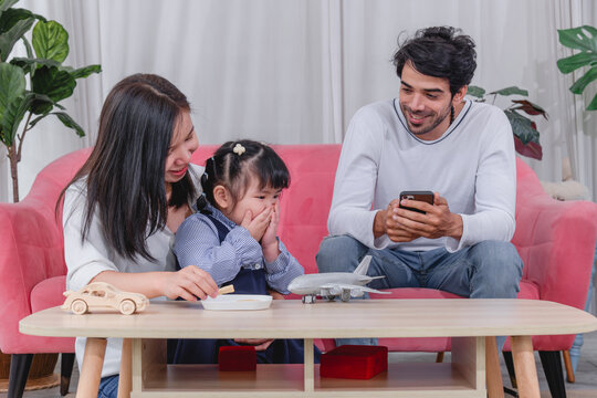 Happy family spending quality time together at home with parents' children enjoying fun and relaxed moment around a table.