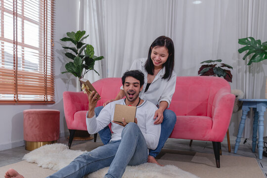 Happy husband and wife relaxing together at home while using tablet and enjoying quality time comfortable sofa.