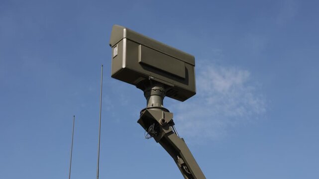 Green military radar is rotating - control, surveillance and monitoring of the clear blue air. High tech technology in the army. 