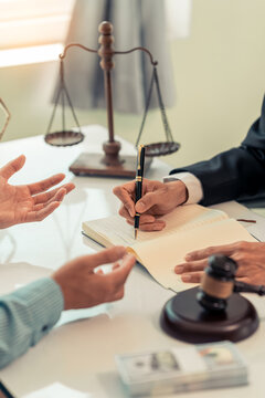 Lawyer and Client Signing Legal Contract Agreement Document in Law Office