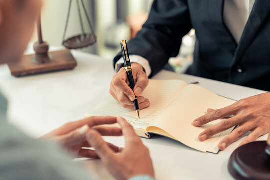 Lawyer and Client Signing Legal Contract Agreement Document in Law Office